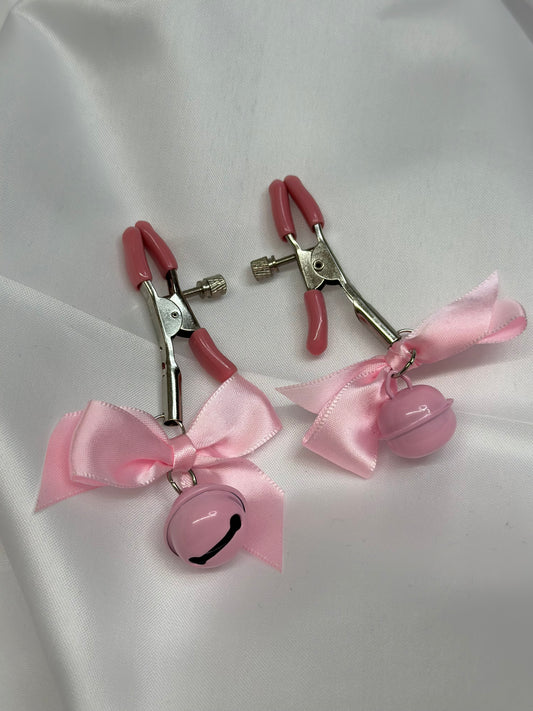 BDSM nipple clamps with decorative bows for playful kink