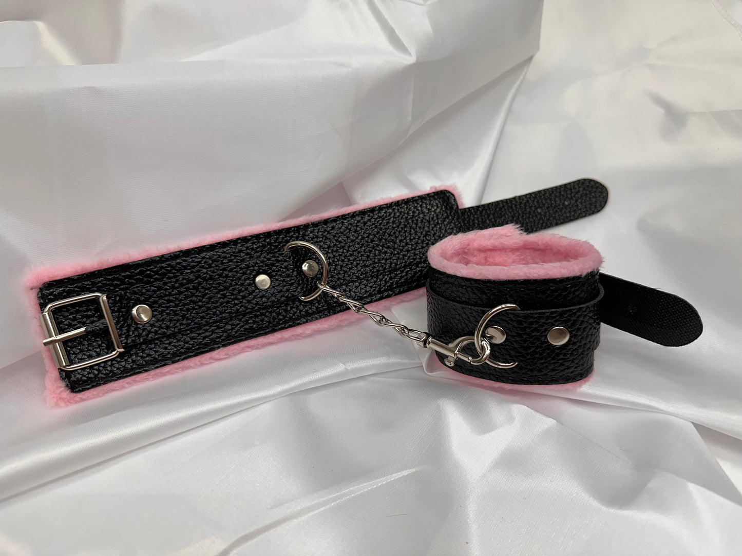 Purple soft faux leather handcuffs with adjustable buckle closure and sturdy metal hardware, perfect for BDSM, roleplay, and cosplay.