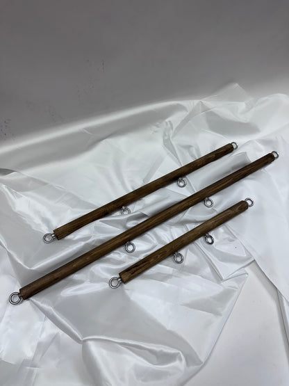 Solid wood spreader bar with metal attachment rings, available in fixed lengths (40, 60, 80 cm), designed for wrist or ankle restraint in BDSM play