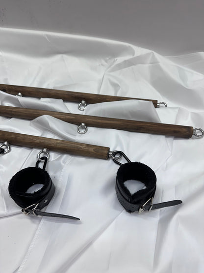 Solid wood spreader bar with metal attachment rings, available in fixed lengths (40, 60, 80 cm), designed for wrist or ankle restraint in BDSM play