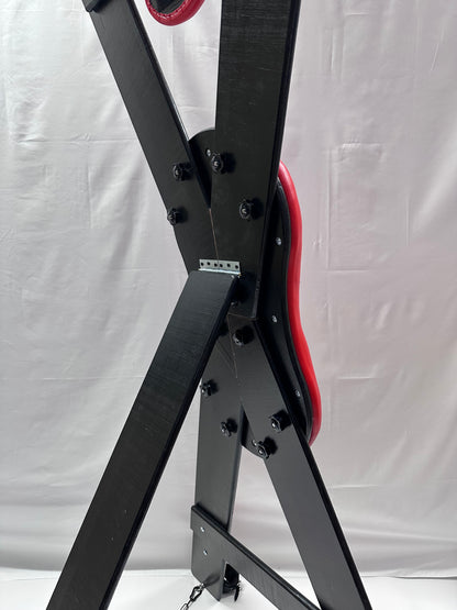 St. Andrew’s Cross made of hardwood with black padded cushions, adjustable restraints, and quick-release hinges for easy storage.

