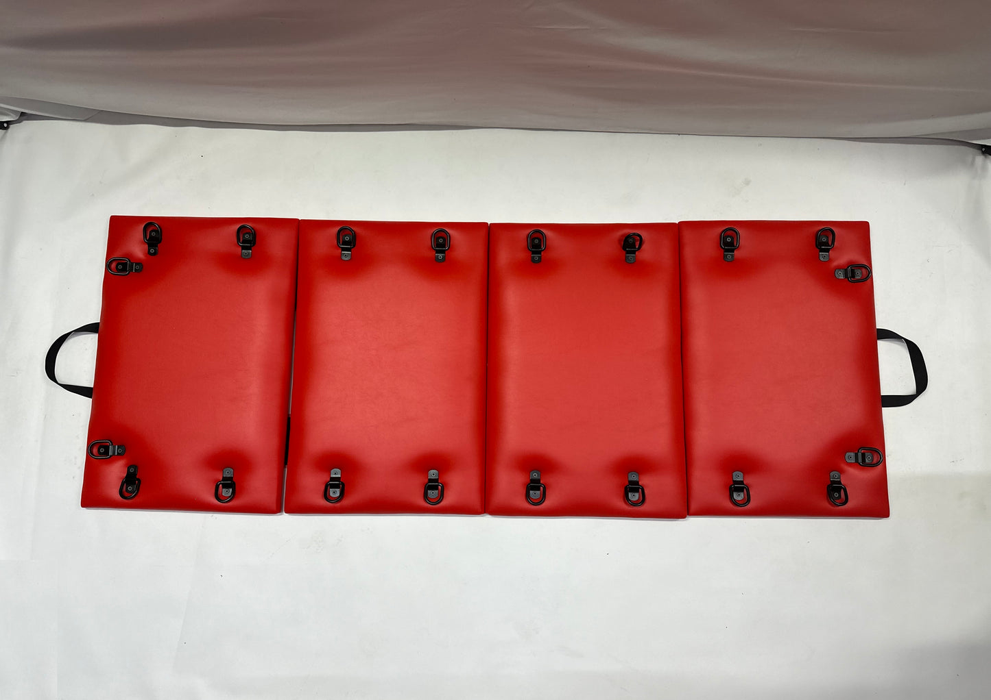 Foldable faux leather spanking bench in black with metal restraint hooks, portable BDSM furniture for bondage play.