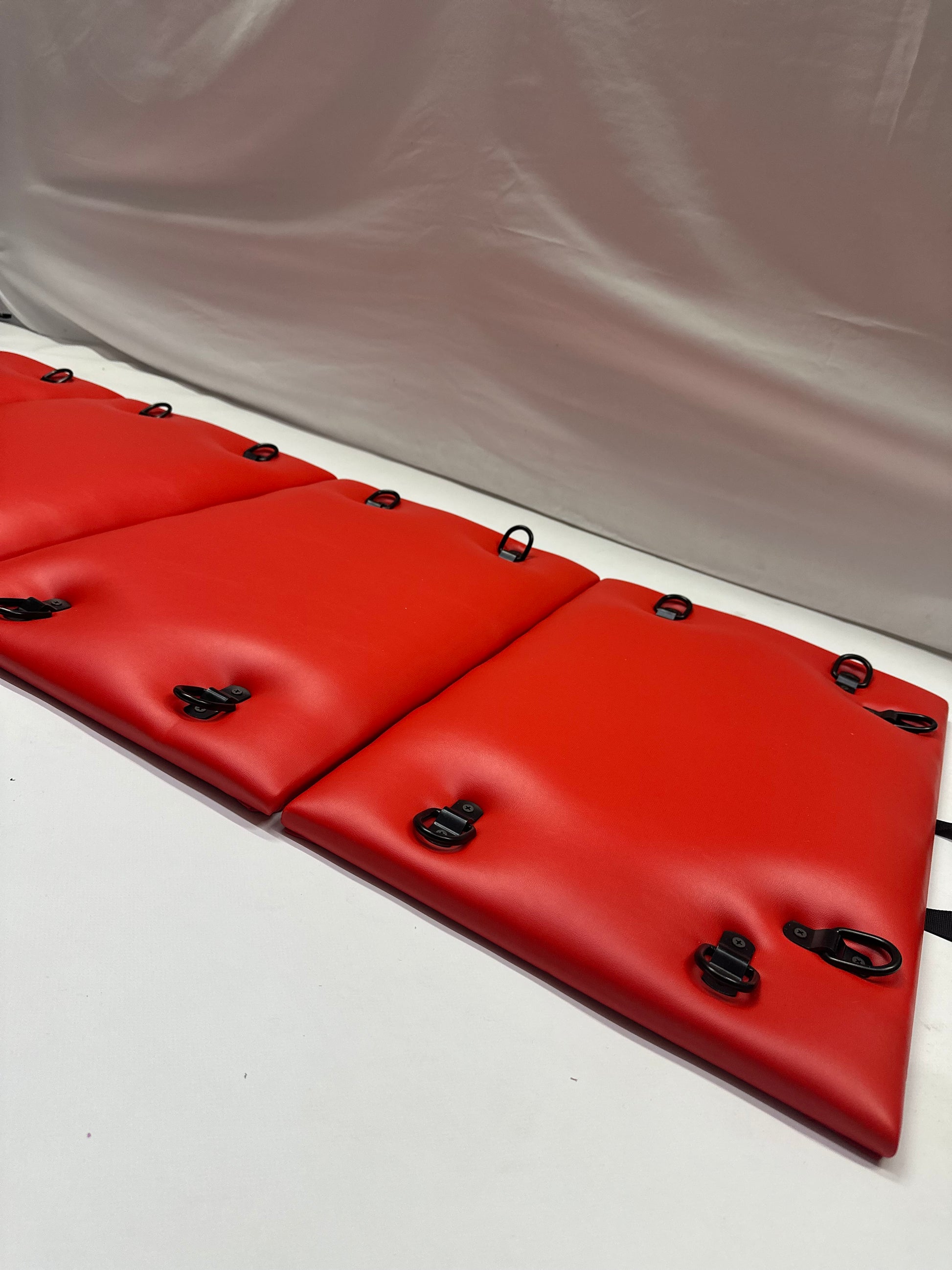 Foldable faux leather spanking bench in black with metal restraint hooks, portable BDSM furniture for bondage play.