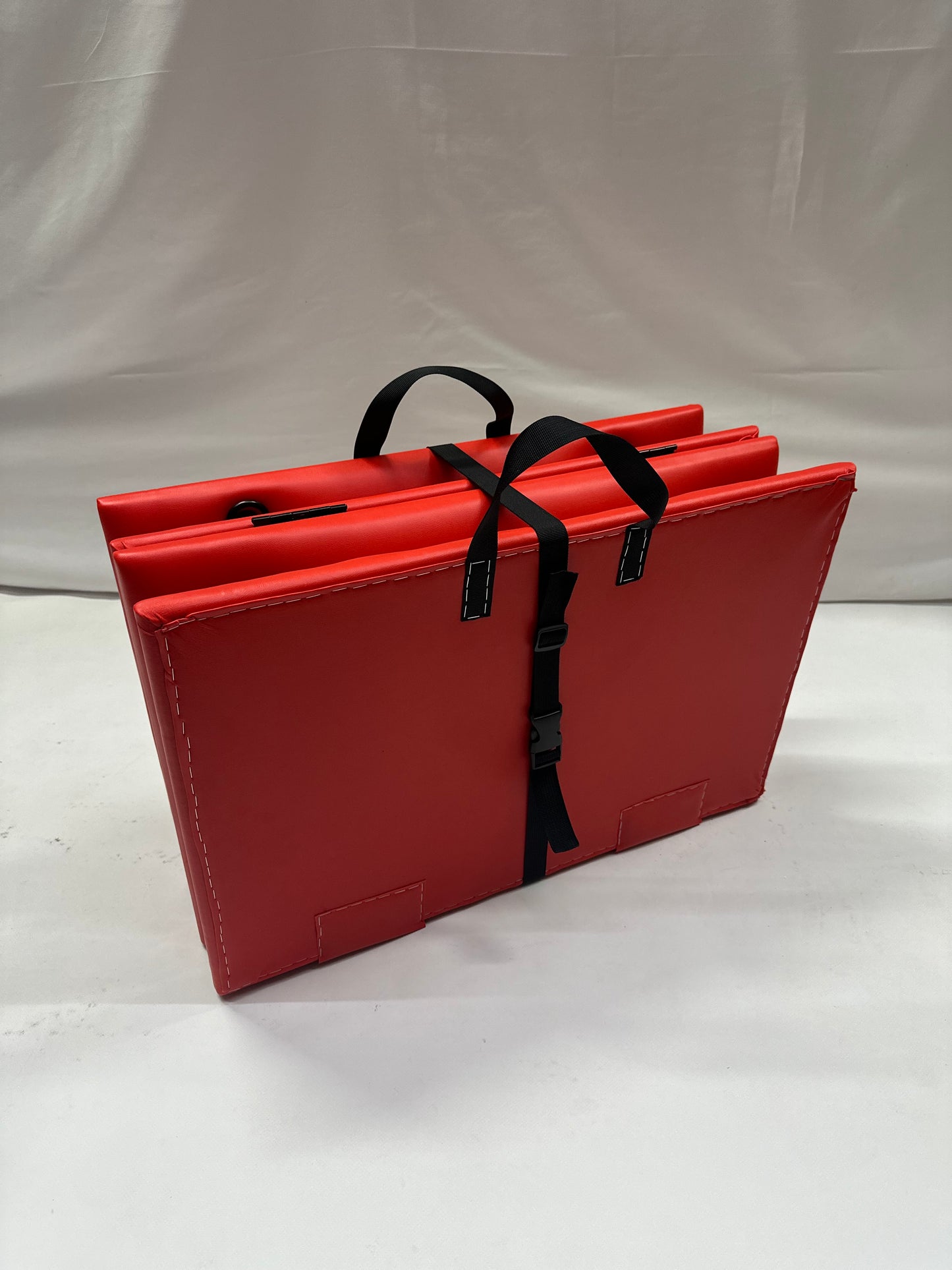 Foldable faux leather spanking bench in black with metal restraint hooks, portable BDSM furniture for bondage play.