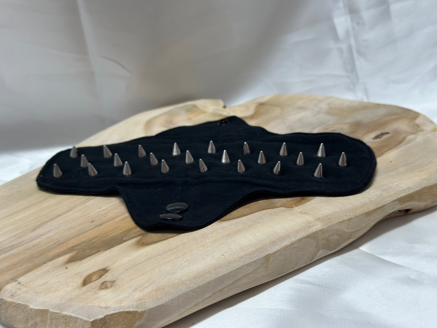 Spiked BDSM discipline pad made of fabric with stainless steel spikes for sensory play and pain exploration.