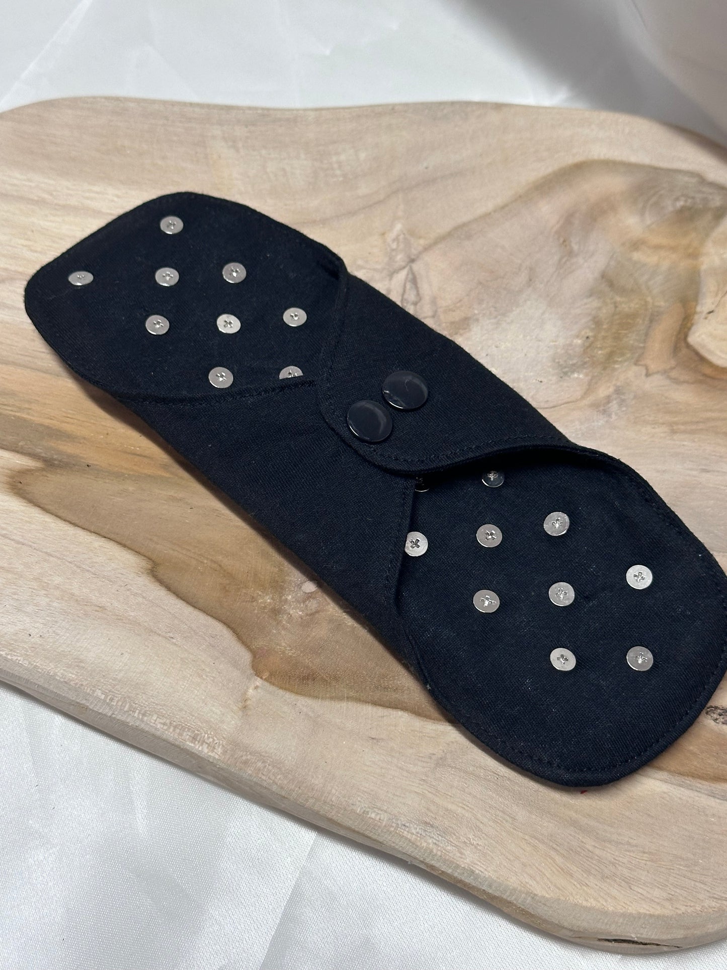Spiked BDSM discipline pad made of fabric with stainless steel spikes for sensory play and pain exploration.