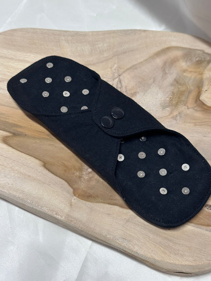 Spiked BDSM discipline pad made of fabric with stainless steel spikes for sensory play and pain exploration.