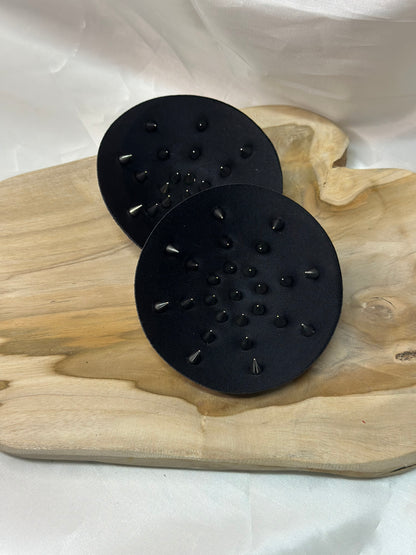 Pair of spiked bra inserts made from fabric with metal spikes for BDSM and sensory play.
