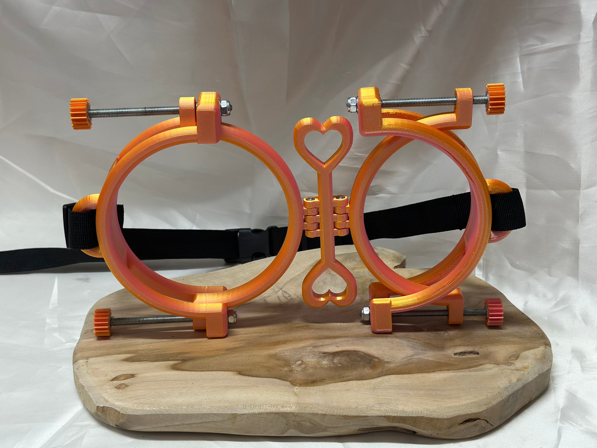 3D printed adjustable breast press bondage restraint with nylon strap for BDSM sensory and fetish play.