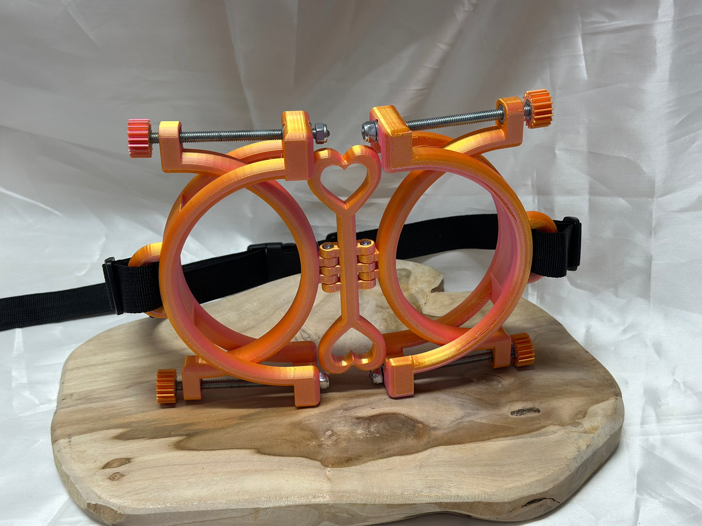 3D printed adjustable breast press bondage restraint with nylon strap for BDSM sensory and fetish play.