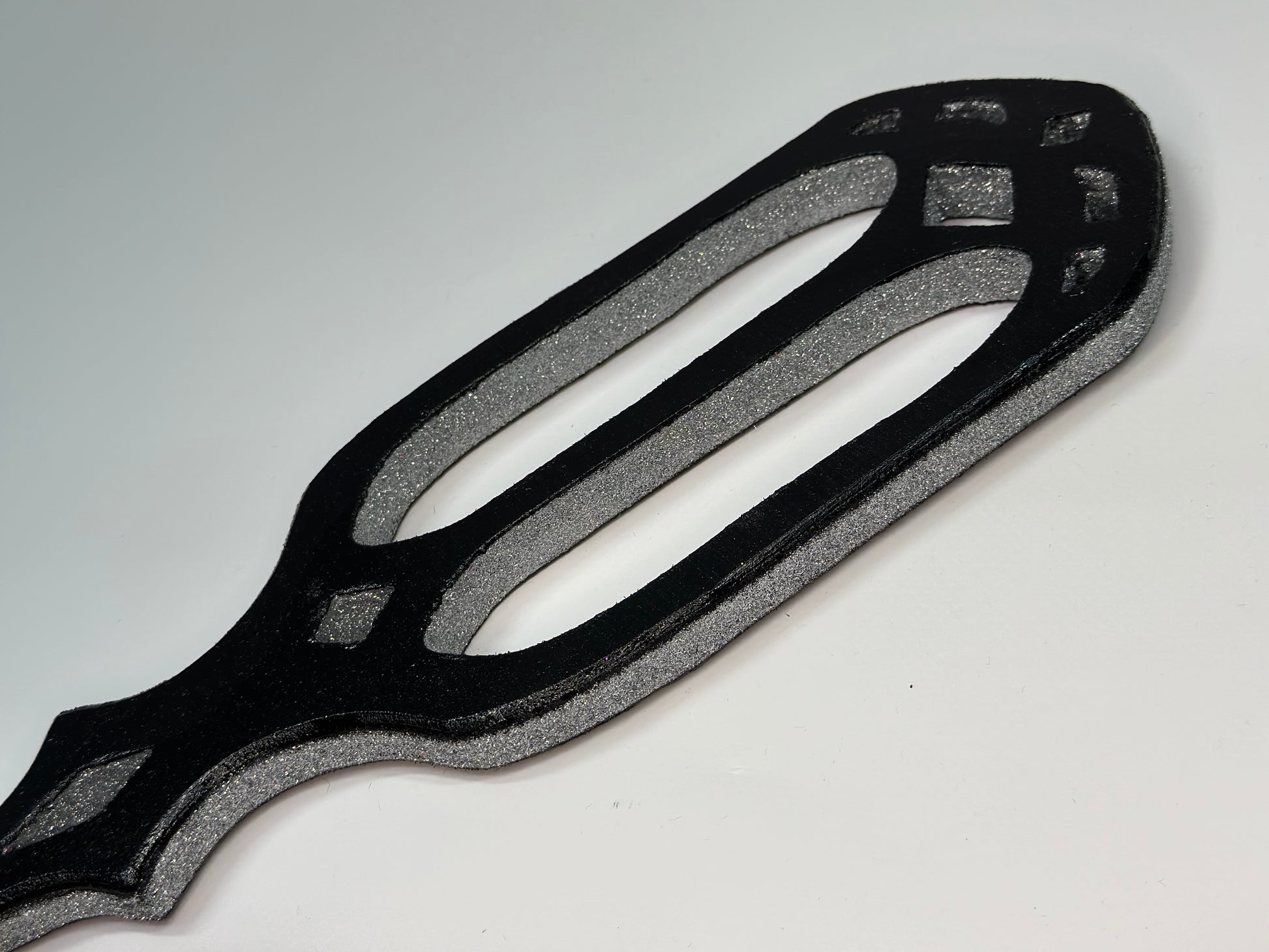 Handmade Gothic Glitter Cathedral Spanking Paddle with intricate cut-outs and a dazzling finish. Crafted from premium hardwood for durability and precision impact. A perfect blend of elegance, artistry, and intensity for both play and display.