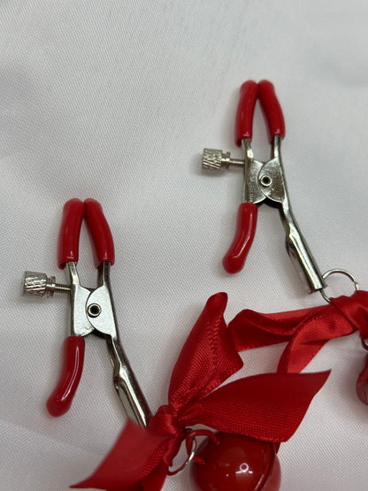BDSM nipple clamps with decorative bows for playful kink
