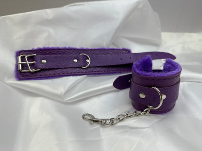 Purple soft faux leather handcuffs with adjustable buckle closure and sturdy metal hardware, perfect for BDSM, roleplay, and cosplay.