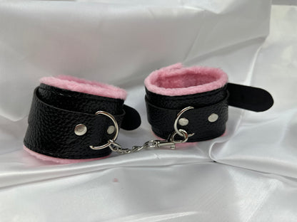Purple soft faux leather handcuffs with adjustable buckle closure and sturdy metal hardware, perfect for BDSM, roleplay, and cosplay.