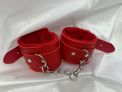 Purple soft faux leather handcuffs with adjustable buckle closure and sturdy metal hardware, perfect for BDSM, roleplay, and cosplay.