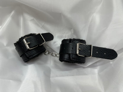 Purple soft faux leather handcuffs with adjustable buckle closure and sturdy metal hardware, perfect for BDSM, roleplay, and cosplay.