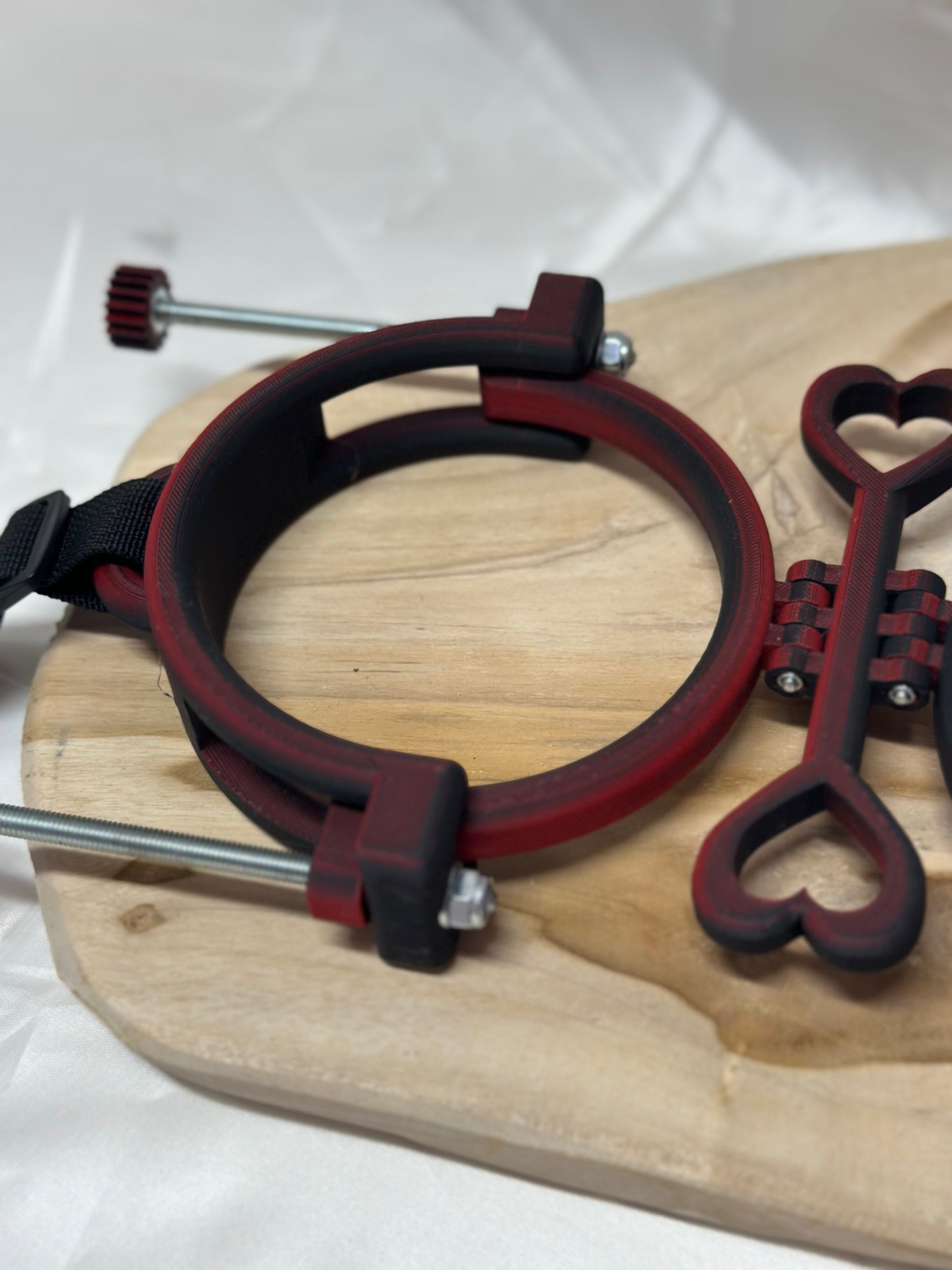 3D printed adjustable breast press bondage restraint with nylon strap for BDSM sensory and fetish play.