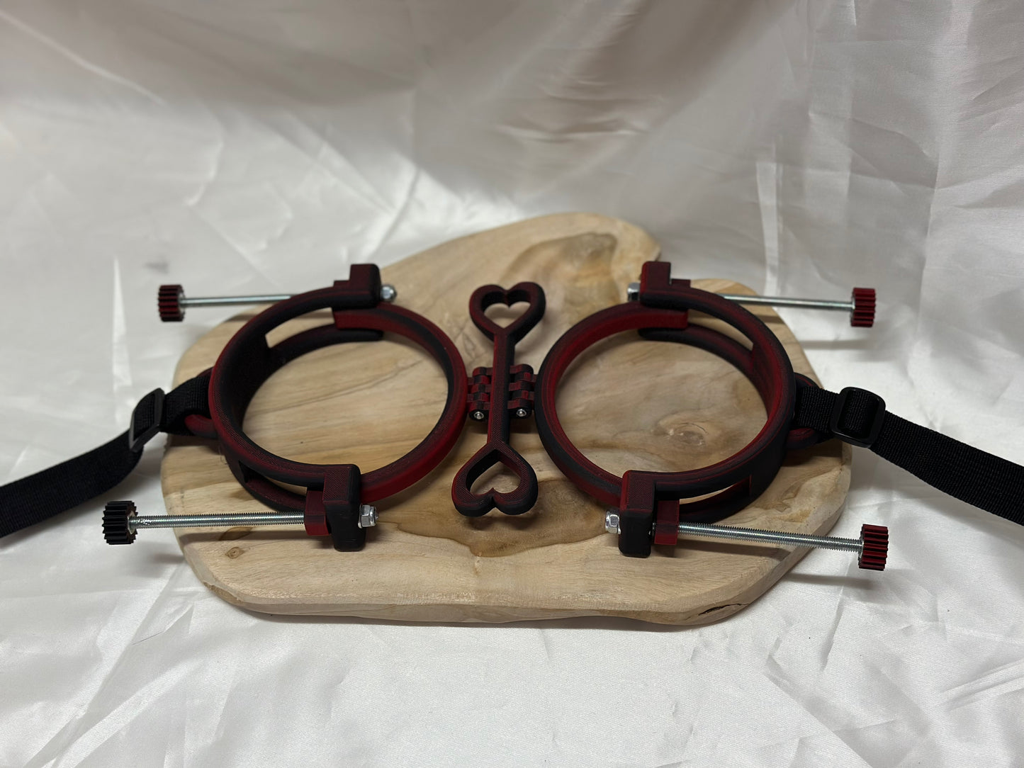 3D printed adjustable breast press bondage restraint with nylon strap for BDSM sensory and fetish play.