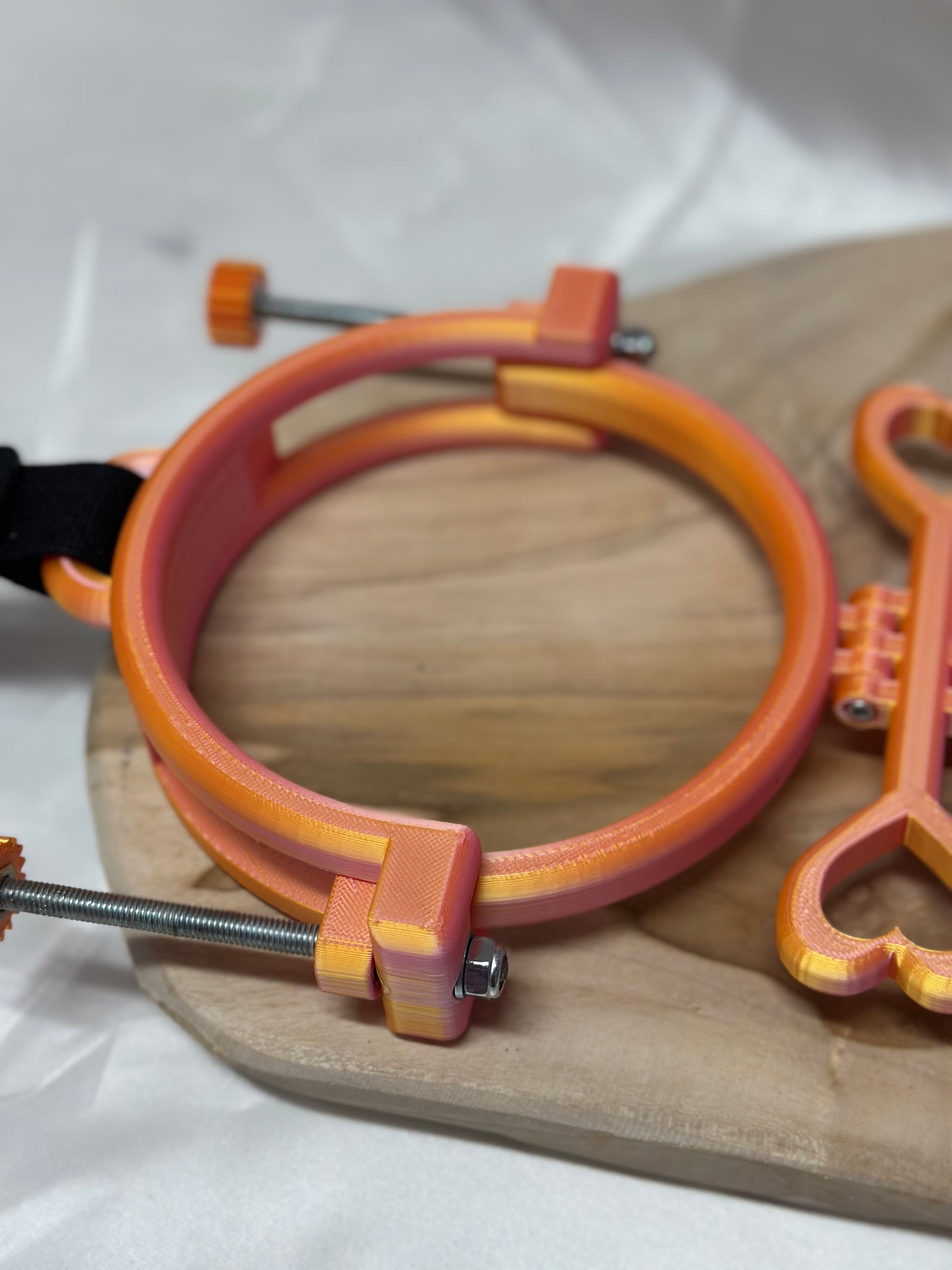 3D printed adjustable breast press bondage restraint with nylon strap for BDSM sensory and fetish play.