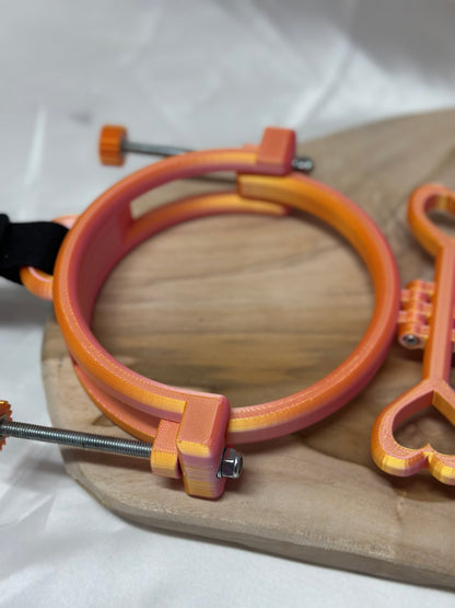 3D printed adjustable breast press bondage restraint with nylon strap for BDSM sensory and fetish play.