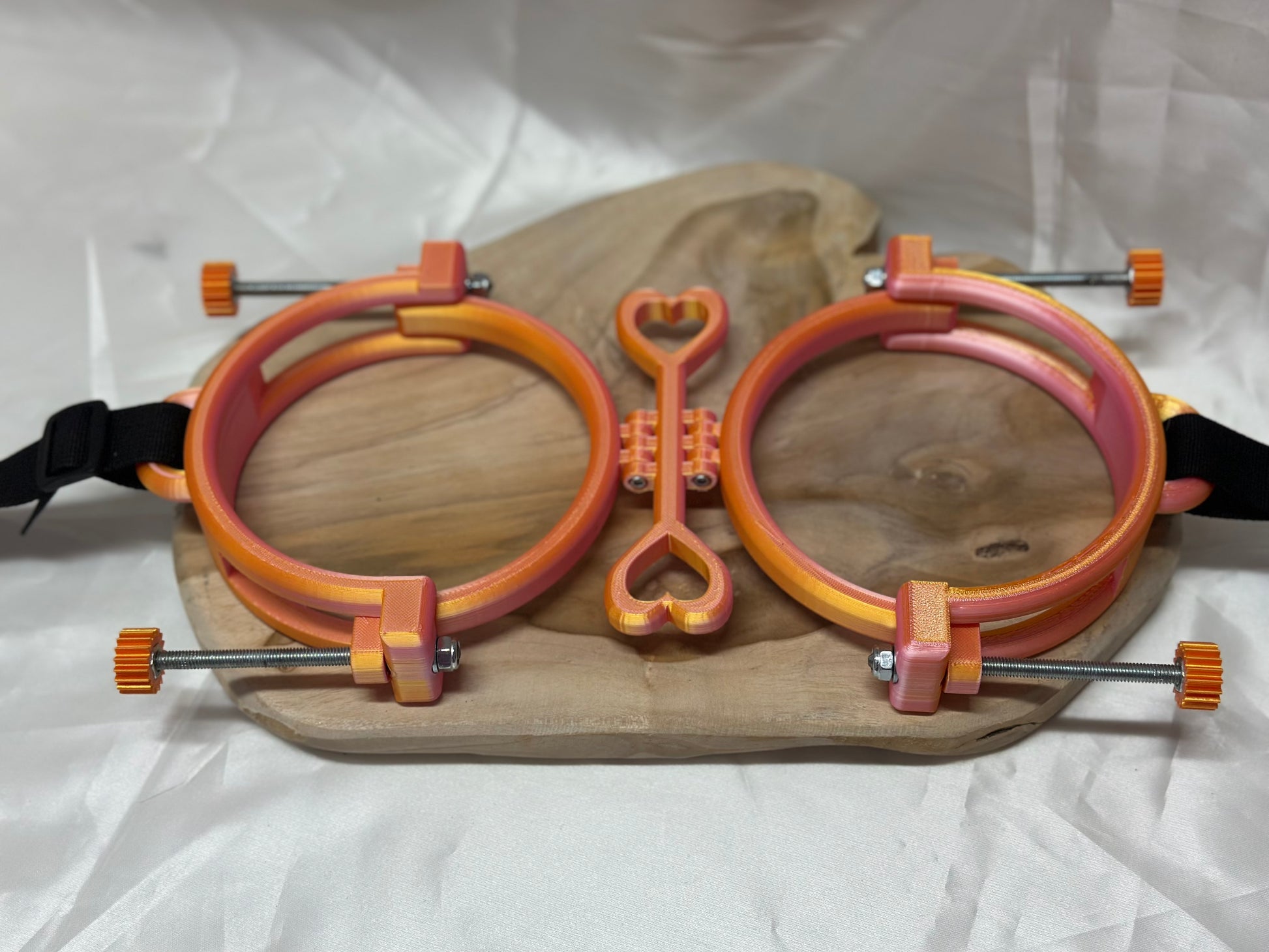 3D printed adjustable breast press bondage restraint with nylon strap for BDSM sensory and fetish play.