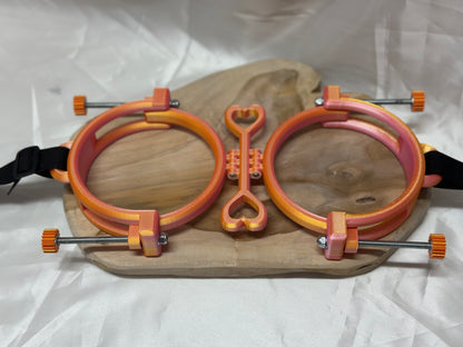 3D printed adjustable breast press bondage restraint with nylon strap for BDSM sensory and fetish play.