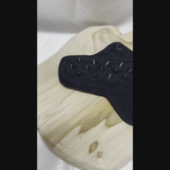 Spiked BDSM discipline pad made of fabric with stainless steel spikes for sensory play and pain exploration.