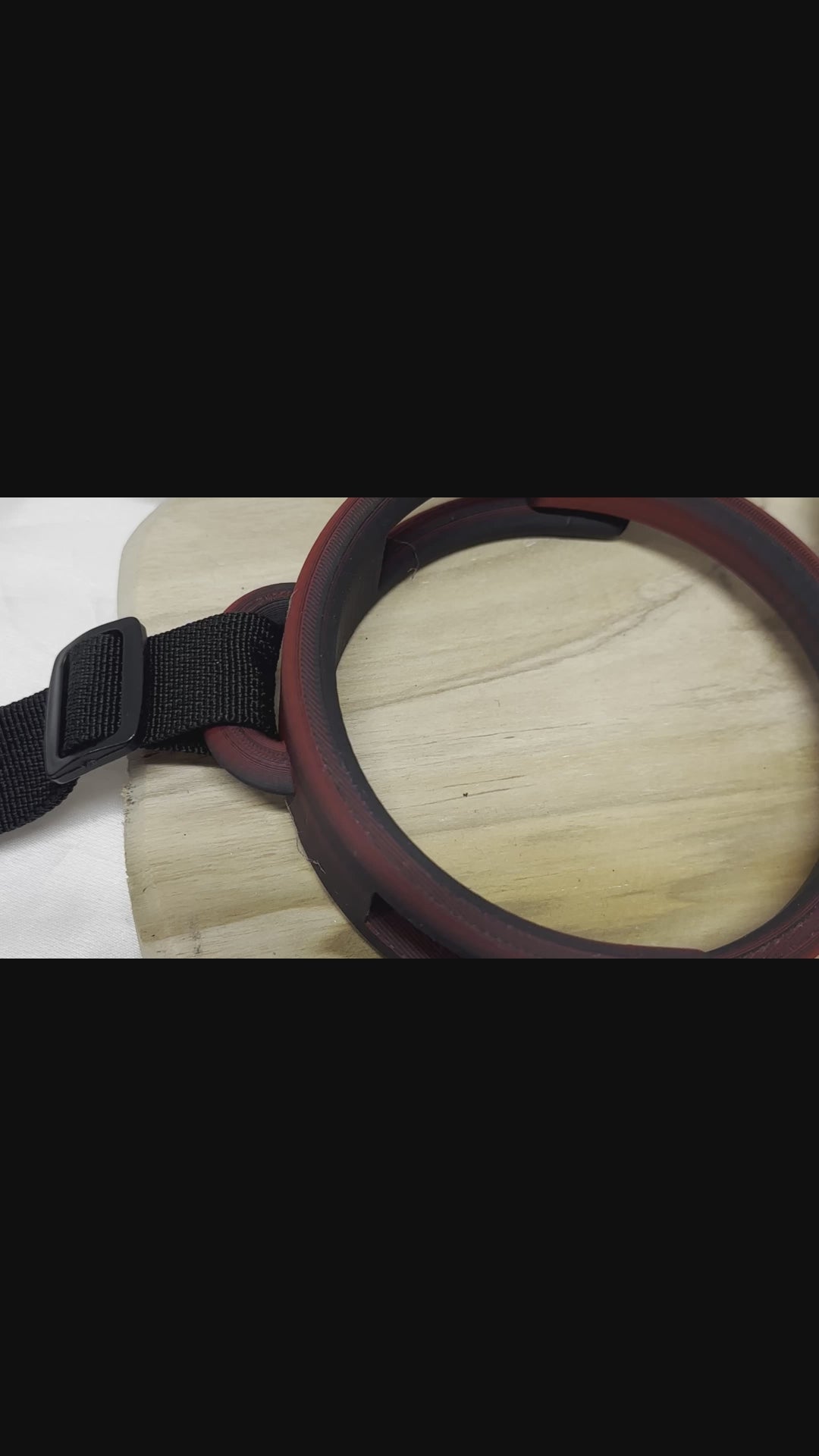 3D printed adjustable breast press bondage restraint with nylon strap for BDSM sensory and fetish play.