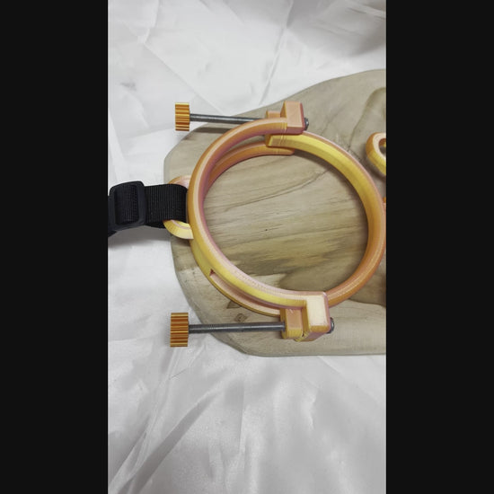 3D printed adjustable breast press bondage restraint with nylon strap for BDSM sensory and fetish play.