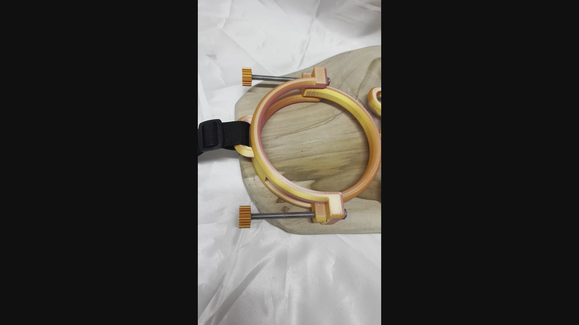 3D printed adjustable breast press bondage restraint with nylon strap for BDSM sensory and fetish play.